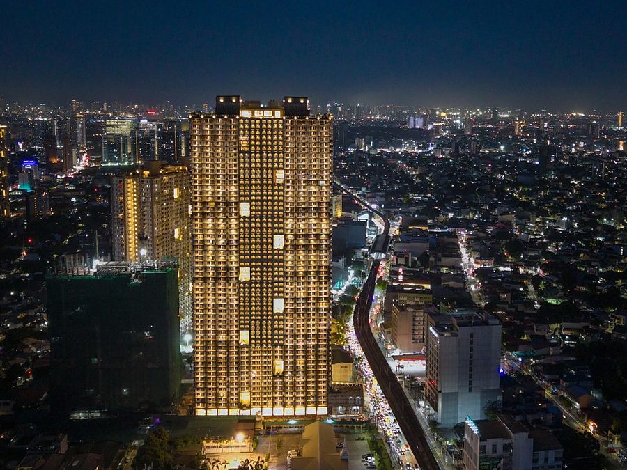 The Oriana North Tower at night — ready-for-occupancy DMCI Homes condominium on Aurora Boulevard, Quezon City.