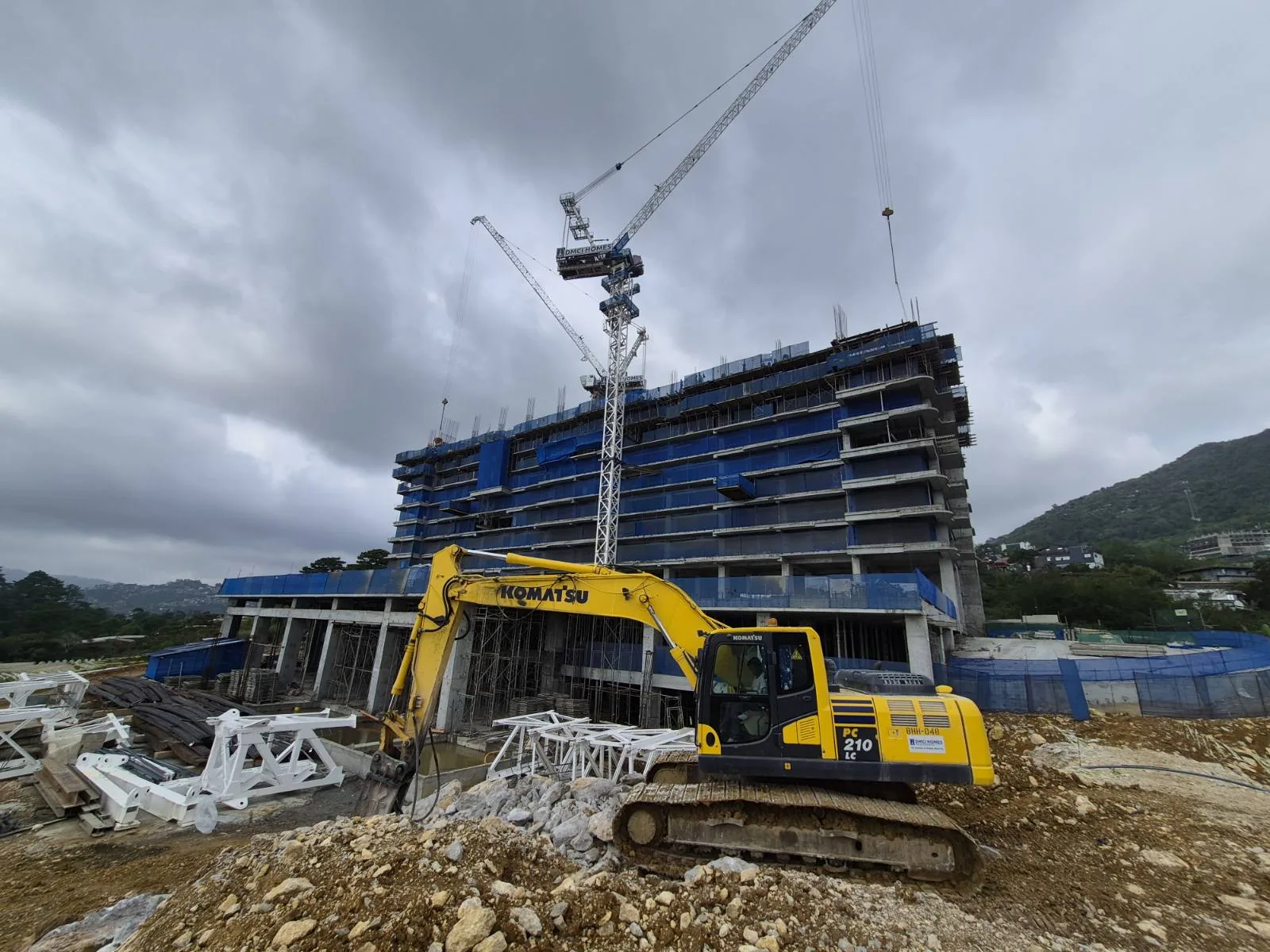 Tower crane and excavator on the Moncello Crest mountainside site