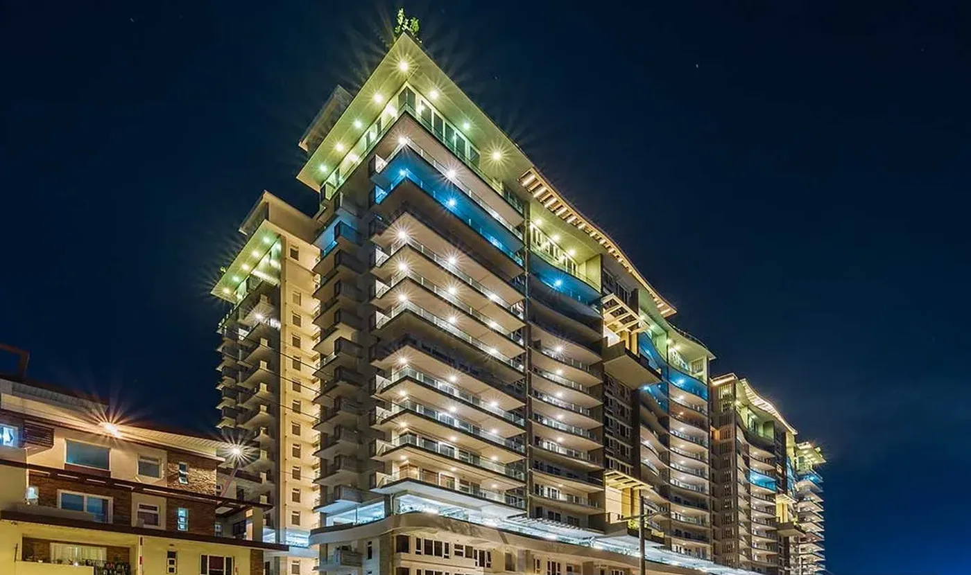 Oak Harbor Residences tower facade lit at night