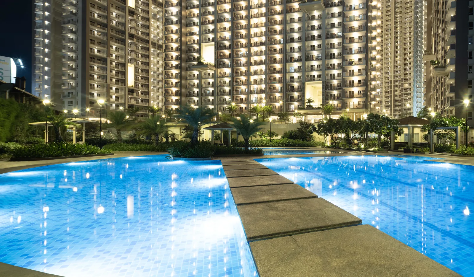 Lounge pool lit at night at Prisma Residences